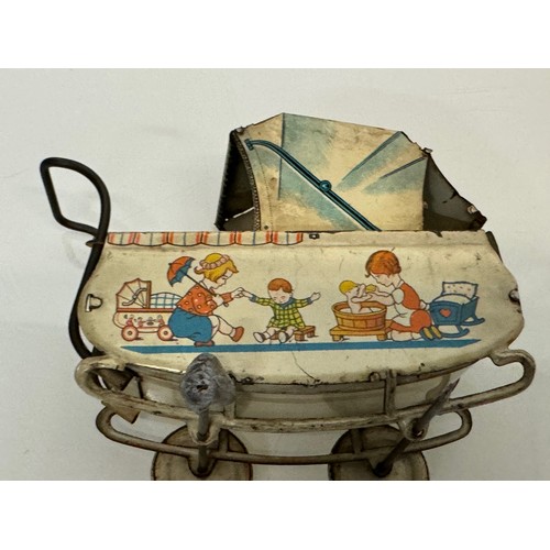 288 - Toys, lithographed tin plate German pram..

This lot is available for in-house shipping