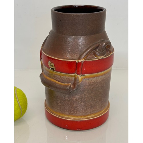 70 - Mid Century West German pottery churn with a three colour glaze externally, 20 cm high.

This lot is... 