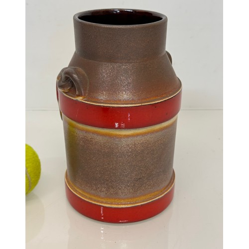 70 - Mid Century West German pottery churn with a three colour glaze externally, 20 cm high.

This lot is... 