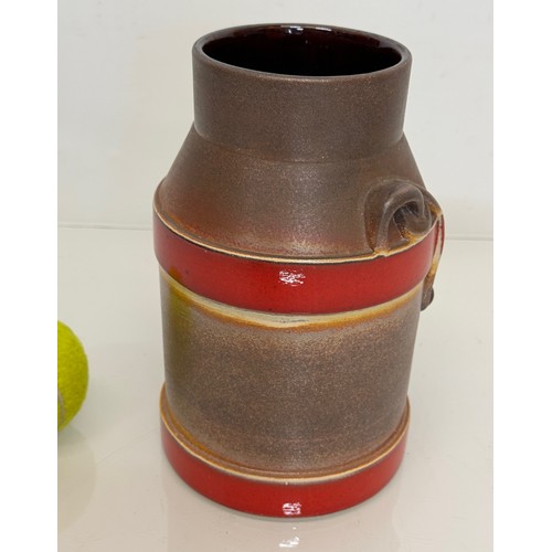 70 - Mid Century West German pottery churn with a three colour glaze externally, 20 cm high.

This lot is... 