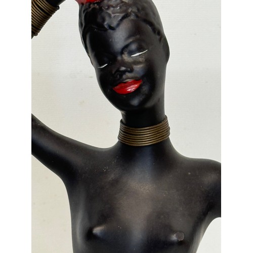 77 - Decorative figurine of a naked black female with a bowl balanced on her head. 45 cm tall.

This lot ... 