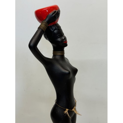 77 - Decorative figurine of a naked black female with a bowl balanced on her head. 45 cm tall.

This lot ... 