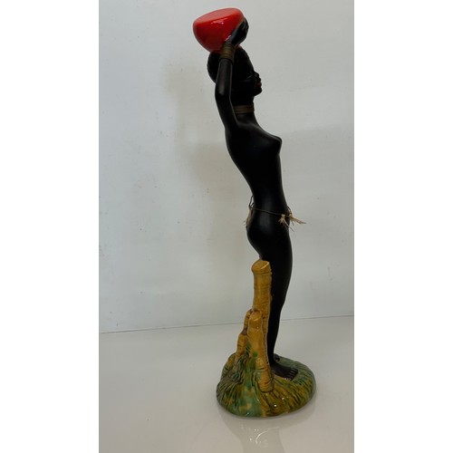 77 - Decorative figurine of a naked black female with a bowl balanced on her head. 45 cm tall.

This lot ... 