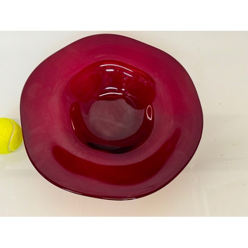 88 - A large dark red coloured art glass bowl 34 cm in diameter.

This lot is available for in-house ship... 