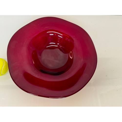 88 - A large dark red coloured art glass bowl 34 cm in diameter.

This lot is available for in-house ship... 