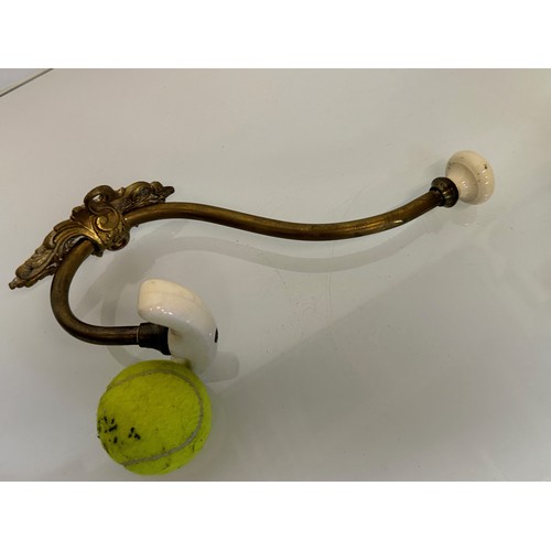 242 - Cast brass coat hanger of significant proportions 33 cm overall length. Lower coat hook finial is 11... 