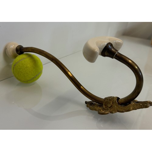 242 - Cast brass coat hanger of significant proportions 33 cm overall length. Lower coat hook finial is 11... 