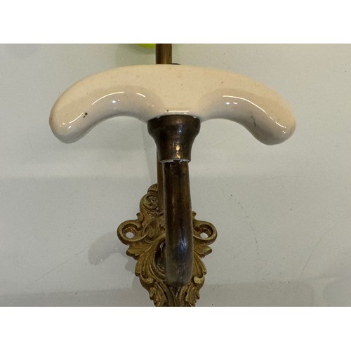 242 - Cast brass coat hanger of significant proportions 33 cm overall length. Lower coat hook finial is 11... 