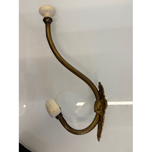 242 - Cast brass coat hanger of significant proportions 33 cm overall length. Lower coat hook finial is 11... 