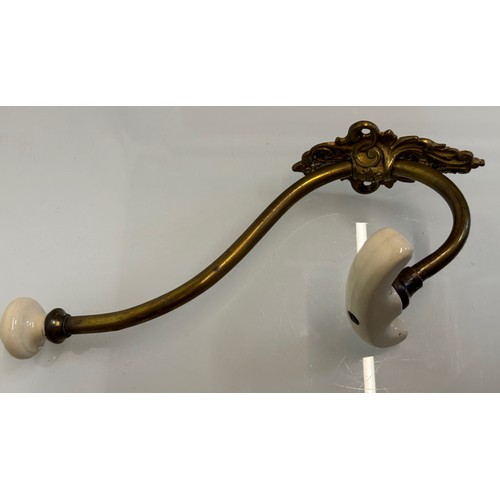 242 - Cast brass coat hanger of significant proportions 33 cm overall length. Lower coat hook finial is 11... 