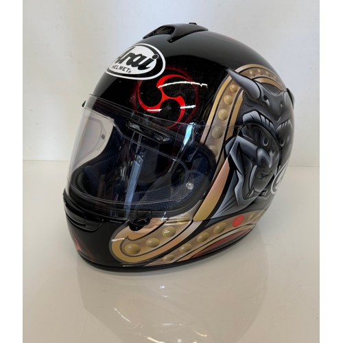 391 - Automobilia, an Arai Chaser motorcycle helmet decorated with devil graphics on a metal flack base co... 