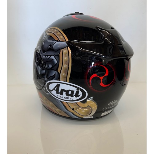 391 - Automobilia, an Arai Chaser motorcycle helmet decorated with devil graphics on a metal flack base co... 