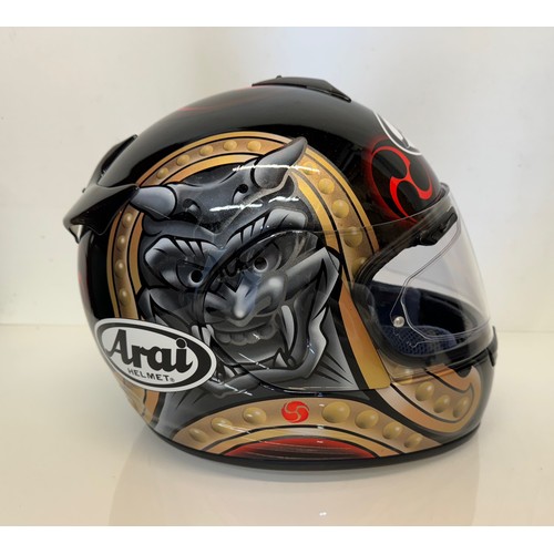 391 - Automobilia, an Arai Chaser motorcycle helmet decorated with devil graphics on a metal flack base co... 