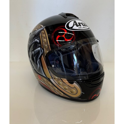 391 - Automobilia, an Arai Chaser motorcycle helmet decorated with devil graphics on a metal flack base co... 