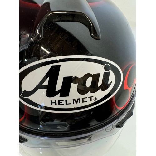 391 - Automobilia, an Arai Chaser motorcycle helmet decorated with devil graphics on a metal flack base co... 