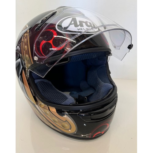 391 - Automobilia, an Arai Chaser motorcycle helmet decorated with devil graphics on a metal flack base co... 