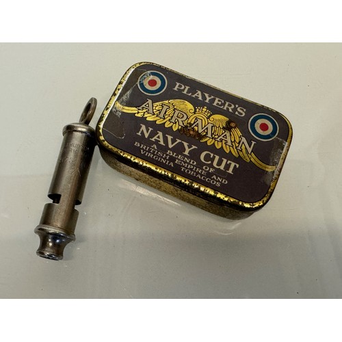 393 - Militaria, A vintage Players Navy cut tobacco tin and a military whistle by Hudson and Co Birmingham... 