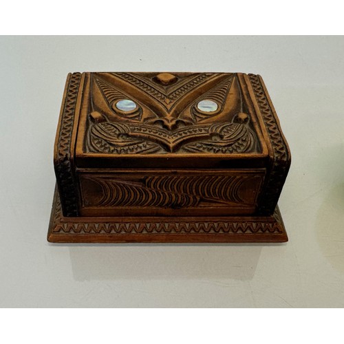 405 - Hand carved lidded box with a mask decoration to the lid with mother of pearl inserts, 12 cm x 9 cm ... 