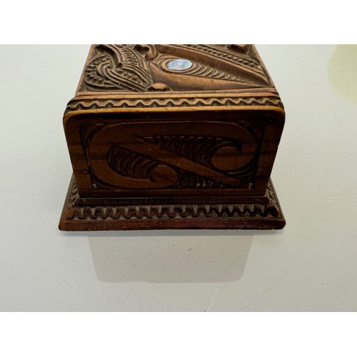 405 - Hand carved lidded box with a mask decoration to the lid with mother of pearl inserts, 12 cm x 9 cm ... 