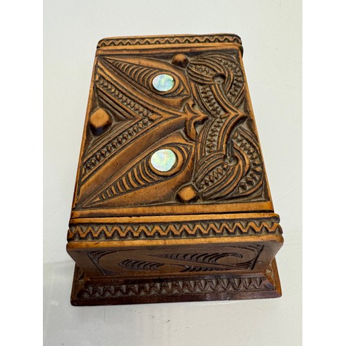 405 - Hand carved lidded box with a mask decoration to the lid with mother of pearl inserts, 12 cm x 9 cm ... 