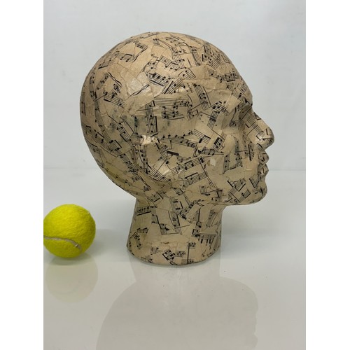 8 - A manakin head decorated with musical notes. 27 cm tall.

This lot is available for in-house shippin... 