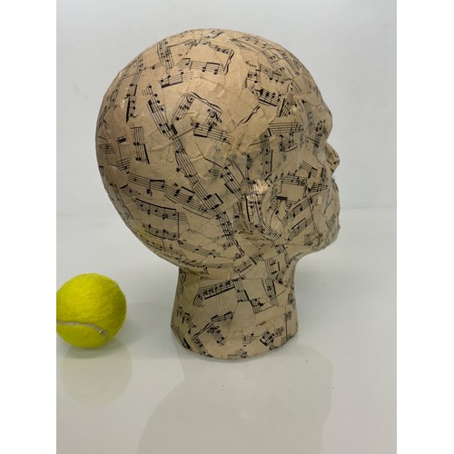 8 - A manakin head decorated with musical notes. 27 cm tall.

This lot is available for in-house shippin... 