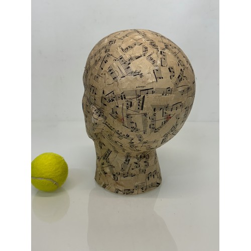 8 - A manakin head decorated with musical notes. 27 cm tall.

This lot is available for in-house shippin... 