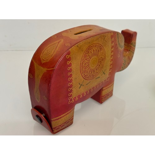 9 - A vintage leather covered money box in the form of an elephant, 20 cm long.

This lot is available f... 