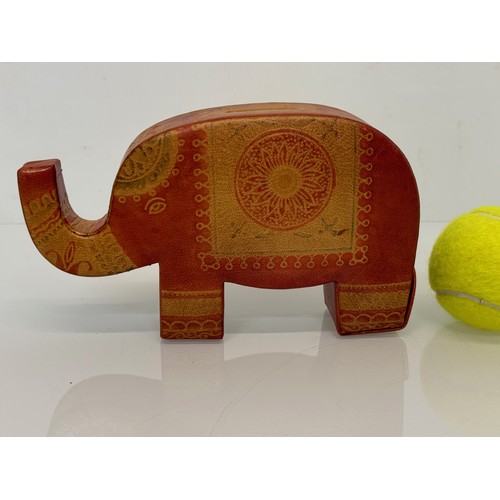 9 - A vintage leather covered money box in the form of an elephant, 20 cm long.

This lot is available f... 