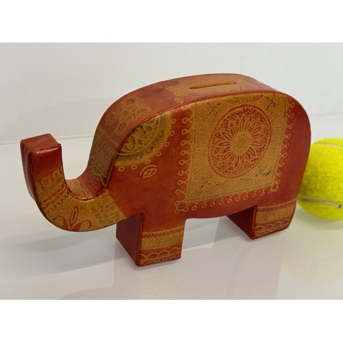 9 - A vintage leather covered money box in the form of an elephant, 20 cm long.

This lot is available f... 