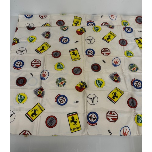 12 - Automobilia, a Les Lees motoring themed scalf decorated with manufacturers badges, Ferrari, Lotus, P... 