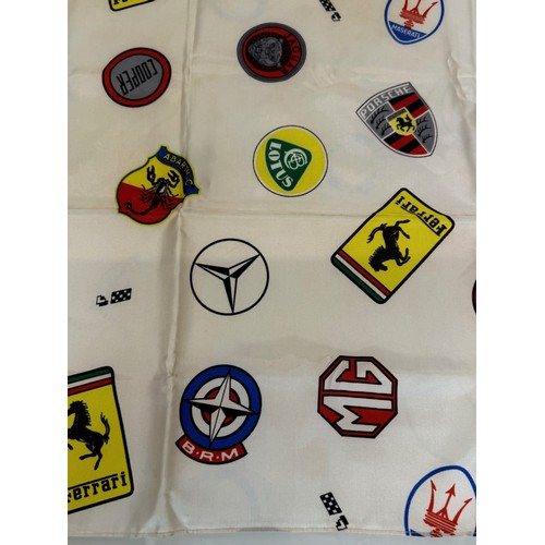 12 - Automobilia, a Les Lees motoring themed scalf decorated with manufacturers badges, Ferrari, Lotus, P... 