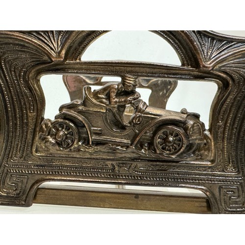 13 - Automobilia, a folding books stand the ends feature an Edwardian racing car at speed.

This lot is a... 