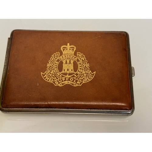 32 - Militaria, a vintage leather bound cigarette case marked for the Suffolk Regiment. 11.5 cm x 8 cm.

... 