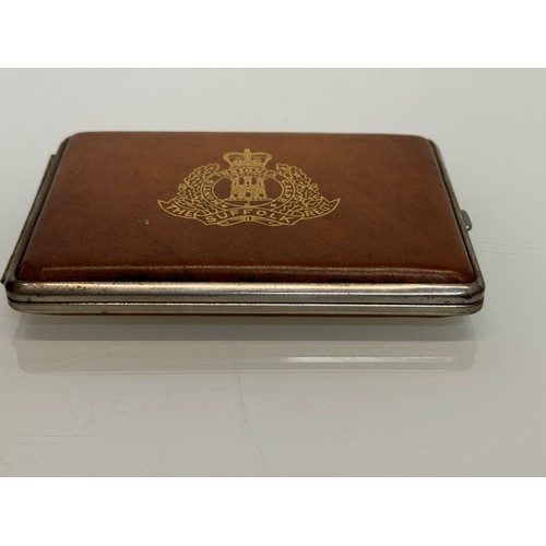 32 - Militaria, a vintage leather bound cigarette case marked for the Suffolk Regiment. 11.5 cm x 8 cm.

... 