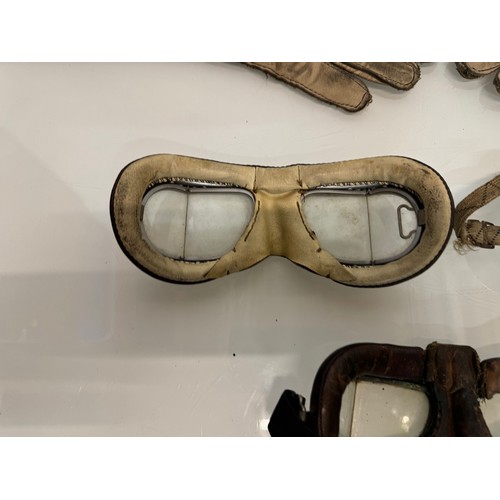 33 - Militaria, RAF, WWII, three pairs of military flying goggles and a pair of leather gauntlets.

This ... 