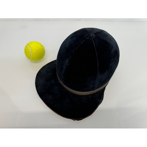 114 - Sporting equipment, a vintage deep blue velvet covered jockeys cap.

This lot is available for in-ho... 