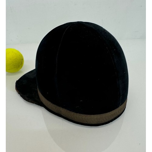 114 - Sporting equipment, a vintage deep blue velvet covered jockeys cap.

This lot is available for in-ho... 