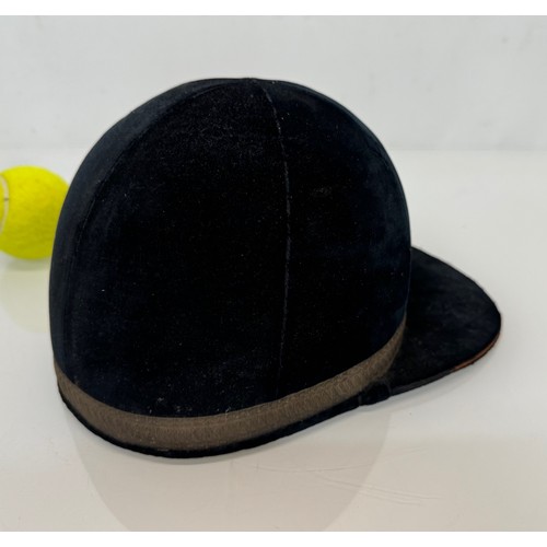 114 - Sporting equipment, a vintage deep blue velvet covered jockeys cap.

This lot is available for in-ho... 