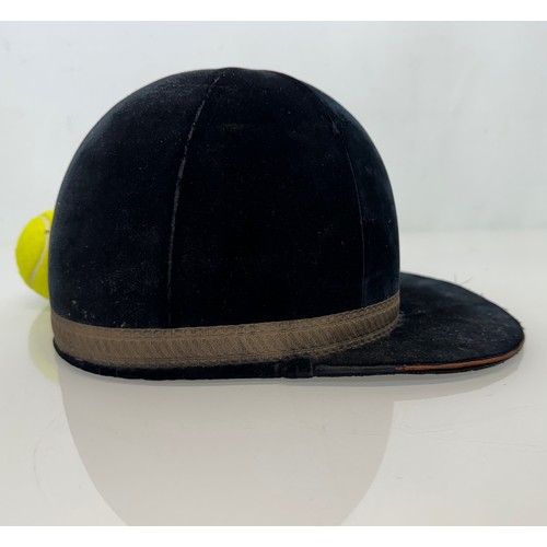 114 - Sporting equipment, a vintage deep blue velvet covered jockeys cap.

This lot is available for in-ho... 