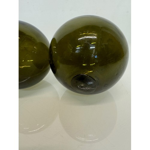 122 - Green glass hand blown fishing net floats 14 cm in diameter.

This lot is available for in-house shi... 