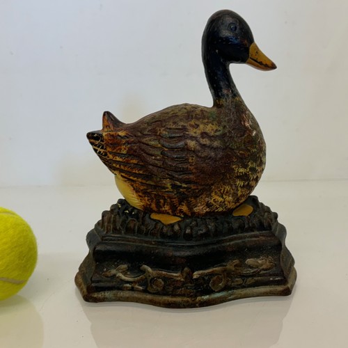 137 - An old cast iron door stop in the shape of a nesting duck. 17 cm wide x 20 cm tall.

This lot is ava... 