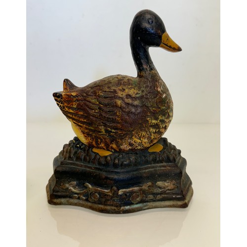 137 - An old cast iron door stop in the shape of a nesting duck. 17 cm wide x 20 cm tall.

This lot is ava... 