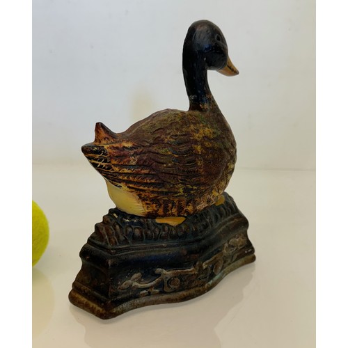 137 - An old cast iron door stop in the shape of a nesting duck. 17 cm wide x 20 cm tall.

This lot is ava... 