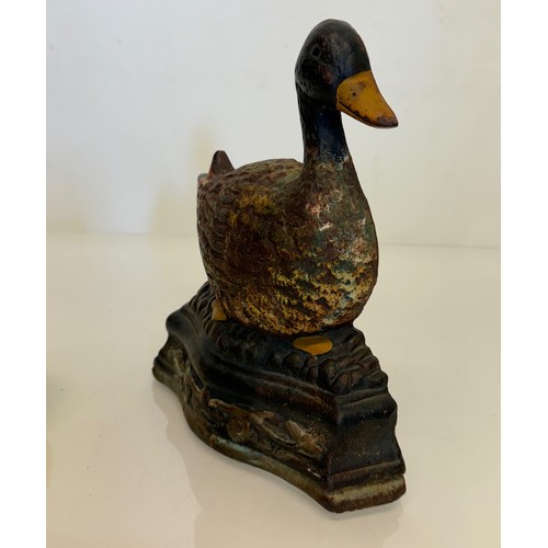 137 - An old cast iron door stop in the shape of a nesting duck. 17 cm wide x 20 cm tall.

This lot is ava... 