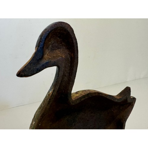 137 - An old cast iron door stop in the shape of a nesting duck. 17 cm wide x 20 cm tall.

This lot is ava... 