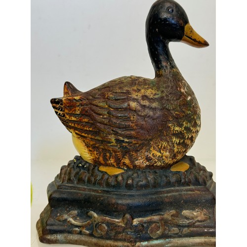 137 - An old cast iron door stop in the shape of a nesting duck. 17 cm wide x 20 cm tall.

This lot is ava... 