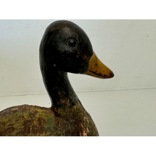 137 - An old cast iron door stop in the shape of a nesting duck. 17 cm wide x 20 cm tall.

This lot is ava... 