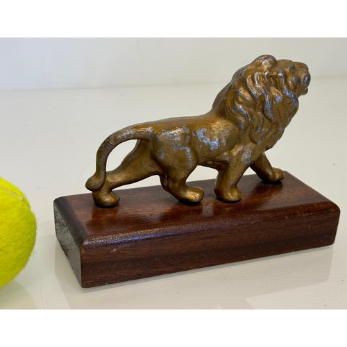 139 - A mounted cast figure of a Lion 18 cm long x 13 cm tall.

This lot is available for in-house shippin... 