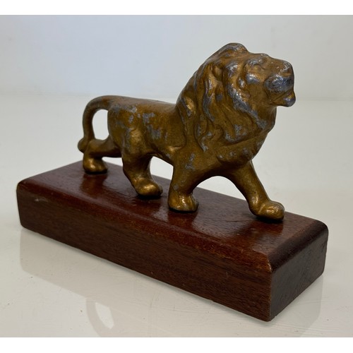 139 - A mounted cast figure of a Lion 18 cm long x 13 cm tall.

This lot is available for in-house shippin... 